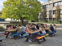 Secondary_school_students_sitting_at_mulitcolour_picnic_table.jpg