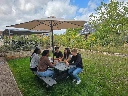 Secondary_school_students_sitting_around_grey_picnic_table_ID017.webp