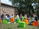 Secondary_school_students_on_coloured_cubes.webp
