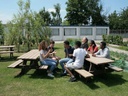 Secondary_school_students_sitting_around_plastic_recycling_picnic_table.jpg